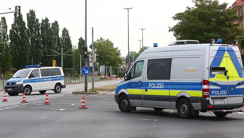 Ein Polizeiauto sperrt die Straße ab. Ein Polizeiauto sperrt die Straße ab.