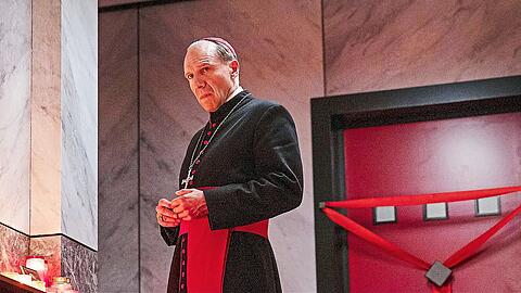 Kardinal Lawrence (Ralph Fiennes) vor der versiegelten Tür des vestorbenen Papstes. Nun muss ein Nachfolger gewählt werden.