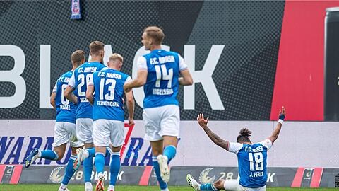 Rostocks Juan Jose Perea (r) jubelt nach seinem Tor zum 1:0 mit seinen Teamkollegen.