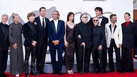 Guillermo del Toro (mit Gehstock) auf dem roten Teppich mit seinen "Frankenstein"-Stars.