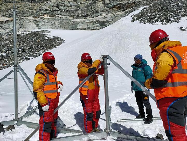 Mitarbeiter von China Mobile errichten in der Nähe des Basislagers des Berges Qomolangma eine 5G-Basisstation.
