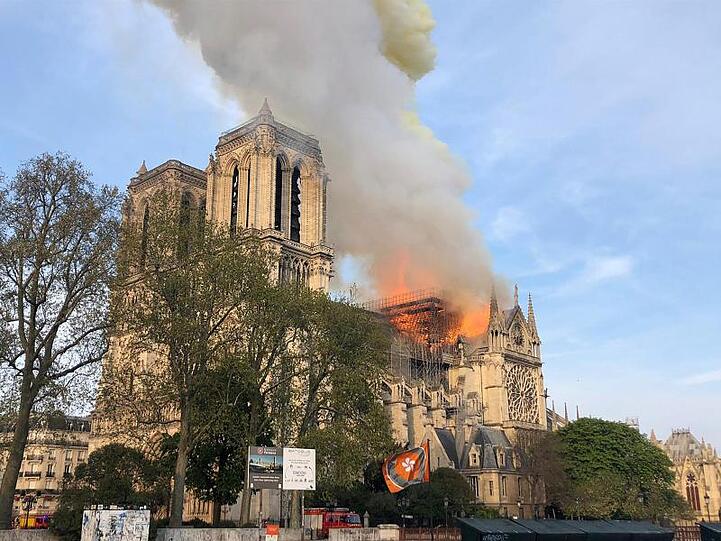 Flammen und Rauch steigen von einem der berühmtesten Wahrzeichen der Welt, der Pariser Kathedrale Notre-Dame, auf.