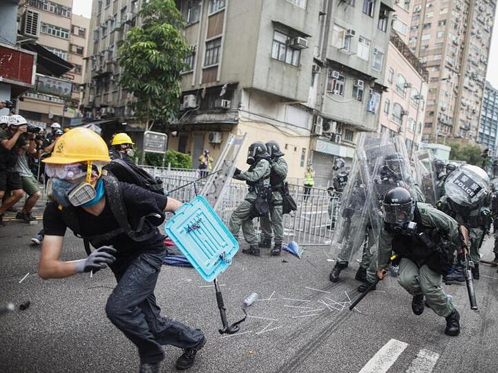 Ein Demonstrant flieht vor Polizisten im Bezirk Yuen Long .