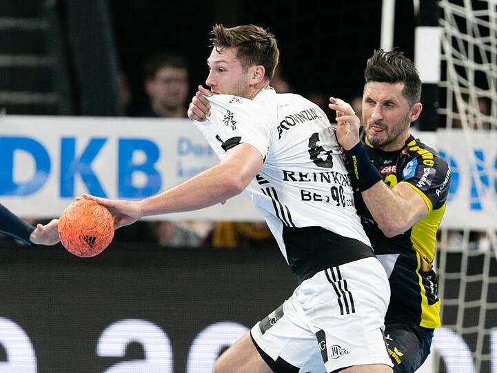 Alexander Petersson von den Rhein-Neckar Löwen (l) verteidigt gegen Harald Reinkind vom THW Kiel.