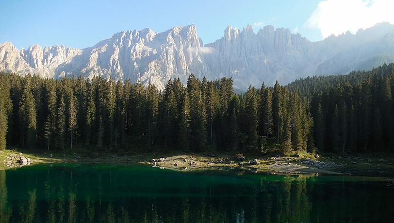 Die Nordwand des Latemar spiegelt sich im türkisblauen Karersee. Die Nordwand des Latemar spiegelt sich im türkisblauen Karersee.