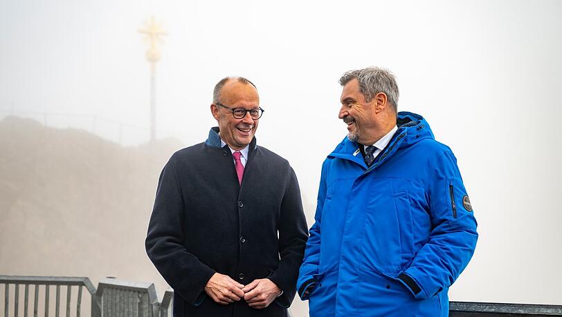 Lächelnd vor leicht bedecktem Himmel: Söder und Merz. Lächelnd vor leicht bedecktem Himmel: Söder und Merz.