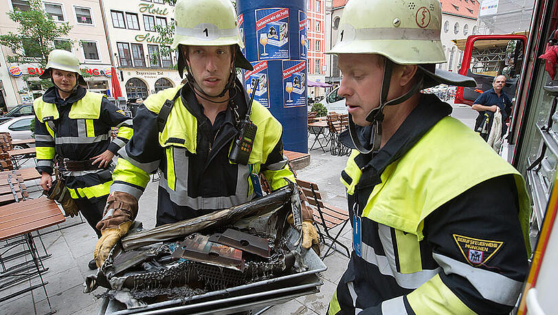 Explosion in Arztpraxis im Tal: Feuerwehrmänner tragen diverse verbrannte Gegenstände in einer Metallschale. Nach Angaben der Polizei wurden bei der Explosion drei Menschen verletzt, einer davon schwer. Explosion in Arztpraxis im Tal: Feuerwehrmänner tragen diverse verbrannte Gegenstände in einer Metallschale. Nach Angaben der Polizei wurden bei der Explosion drei Menschen verletzt, einer davon schwer.
