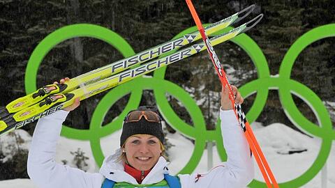 Magdalena Neuner feiert vor den Olympischen Ringen in Whistler ihre Silbermedaille.