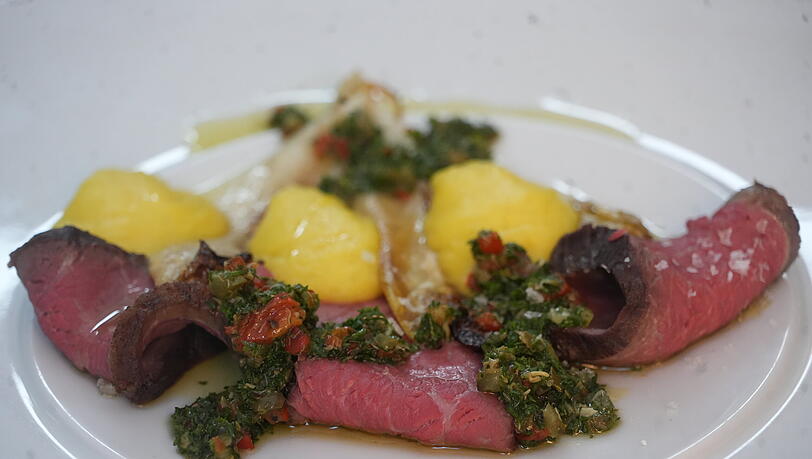 Picanha vom Staffelsee: Hüftdeckel vom Murnauer Premium-Rind, Tapioka-Kurkuma, Italo-Chimichuri und Ofen-Chicorée. Picanha vom Staffelsee: Hüftdeckel vom Murnauer Premium-Rind, Tapioka-Kurkuma, Italo-Chimichuri und Ofen-Chicorée.
