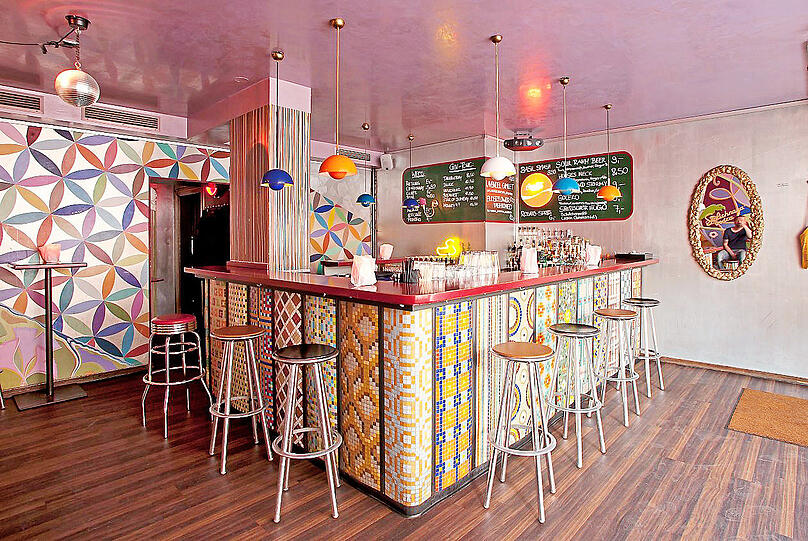 In der Vega Bar in der Georgenstraße 56 feiern Hipster und Nachbarn zusammen zwischen Blumentapete und Mosaik.