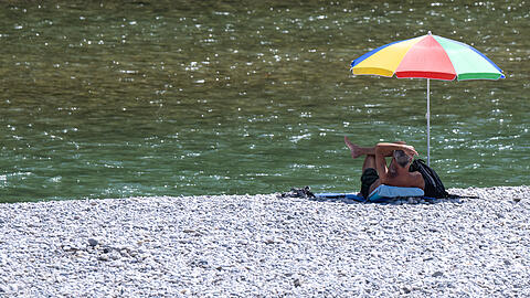 Wenn's an die Isar geht, sollte der Sonnenschirm dieser Tage unbedingt im Gepäck sein. (Archivbild)