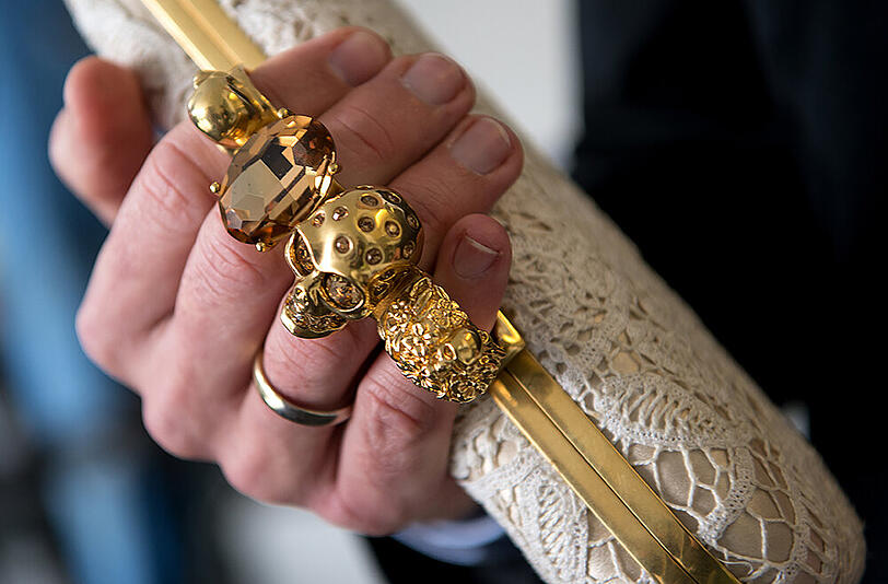 Eine Handtasche, die wie ein Schlagring getragen werden kann