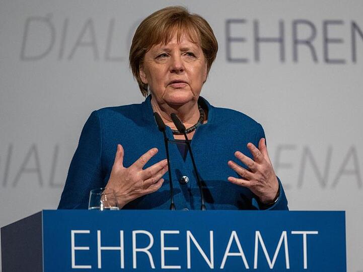 Bundeskanzlerin Angela Merkel (CDU) spricht vor ehrenamtlichen Helfern. Foto: Armin Weigel/dpa