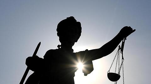 Die Statue der Justitia steht mit einer Waage und einem Schwert in der Hand. Foto: Arne Dedert/dpa/Archivbild