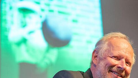 Axel Milberg, Schauspieler, sitzt bei der Lesung zu seinem Buch "Düsternbrook" auf der Bühne. Foto: Lino Mirgeler