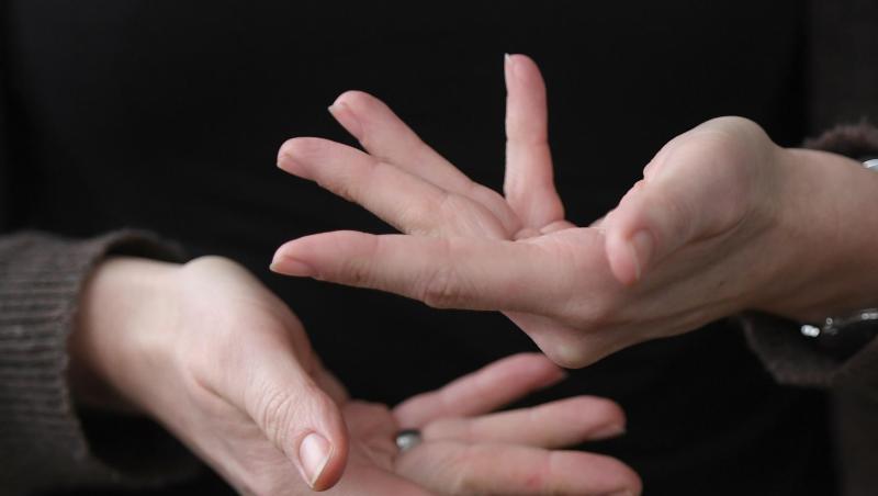 Eine Gebärdendolmetscherin zeigt mit ihren Fingern das Wort "beraten" in Gebärdensprache. (Symbolbild)