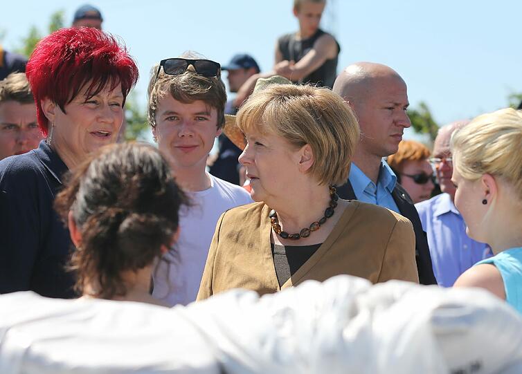 Bundeskanzlerin Angela Merkel (CDU) besucht am einen Hochwasserschwerpunkt an einem Deich aus Sandsäcken in Bitterfeld-Wolfen