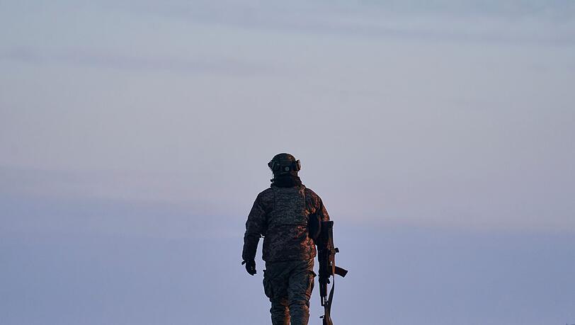 Ein ukrainischer Soldat geht zu seiner Position an der Frontlinie in der Nähe von Bachmut. Die Stadt ist heftig umkämpft.