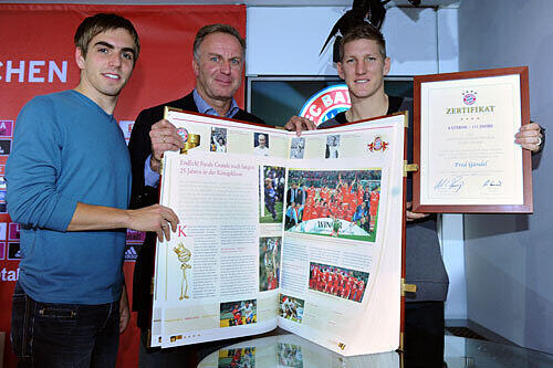 Vorstandsboss Karl-Heinz Rummenigge und die Spieler Philipp Lahm und Bastian Schweinsteiger mit der Bayern-Chronik.