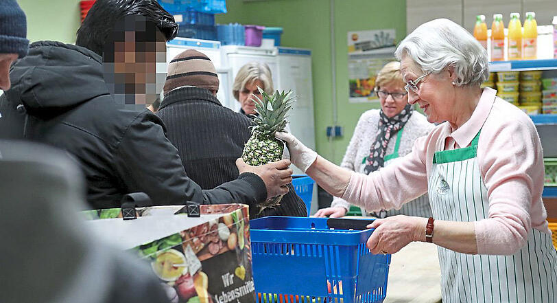 Ehrenamtliche geben Lebensmittel aus. Manchmal gibt es Rezept-Tipps.