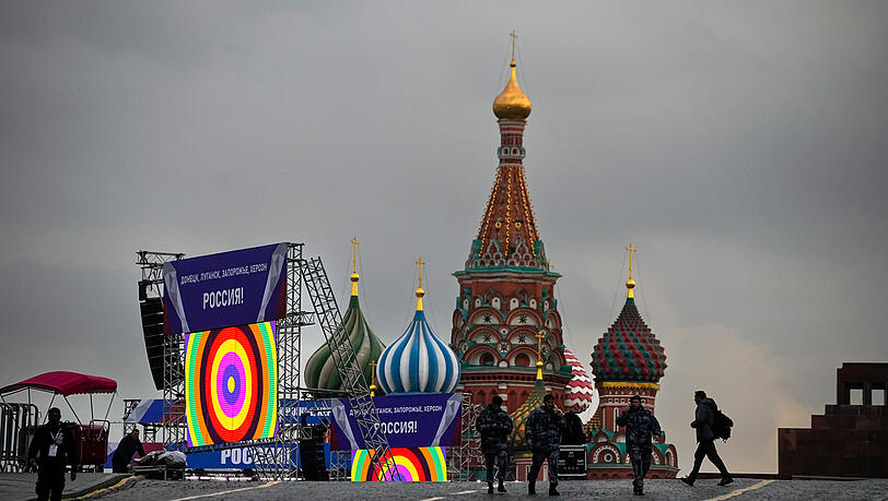 Moskau: Polizisten am Rande eines geplanten Konzerts auf dem Roten Platz - zu sehen sind Banner mit der Aufschrift "Donezk, Luhansk, Saporischschja, Cherson, Russland".