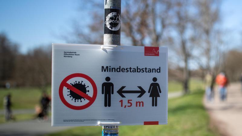 "Mindestabstand 1,5 Meter" zwischen Personen wegen des Coronavirus steht auf einem Schild am Rande eines Gehweges. Foto: Daniel Karmann/dpa "Mindestabstand 1,5 Meter" zwischen Personen wegen des Coronavirus steht auf einem Schild am Rande eines Gehweges. Foto: Daniel Karmann/dpa