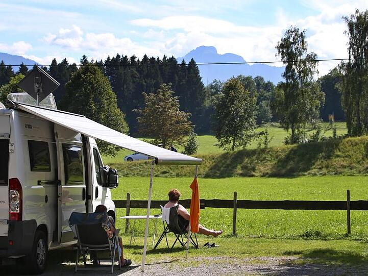 Urlauber genießen auf einem Campingplatz am bayerischen Forggensee das schöne Wetter. Foto: Karl-Josef Hildenbrand/Archivbild