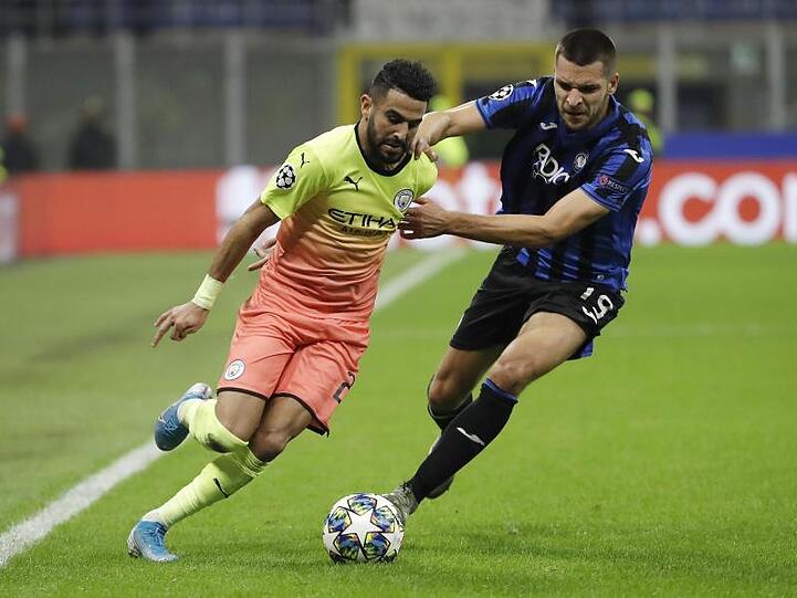 Riyad Mahrez (l) von Manchester City in Aktion gegen Berat Djimsiti von Atalanta Bergamo.
