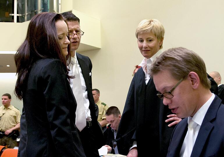 Die Angeklagte Beate Zschäpe (links) steht zum Prozessauftakt im Gerichtssaal in München und unterhält sich mit ihren Anwälten Wolfgang Stahl, Wolfgang Heer (rechts) und Anja Sturm .