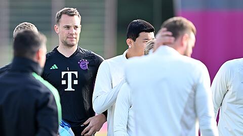 Torwart Manuel Neuer (2.v.l) steht während einer Trainingseinheit des FC Bayern München zwischen seinen Mitspielern.
