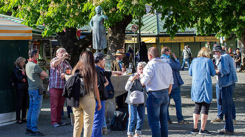Ein Bild von Ende April: Menschen trinken am Liesl-Karlstadt-Brunnen auf dem Viktualienmarkt &ndash; ohne Mindestabstand. (Archivbild)