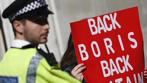Ein Polizist steht neben einem Pro-Brexit-Demonstranten in London. Premier Boris Johnson will vor allem eine Änderung beim Backstop erreichen.