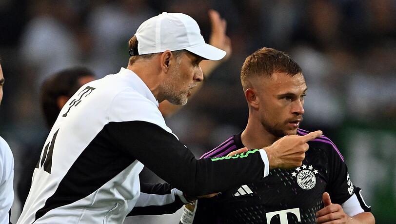 Bayerns Trainer Thomas Tuchel (l) gibt Joshua Kimmich Anweisungen.