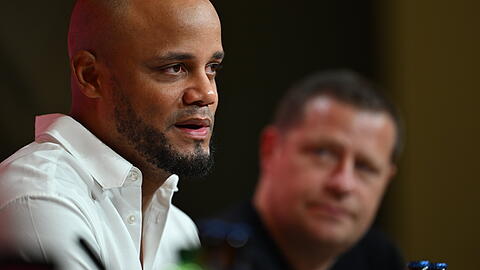 Vincent Kompany (li.) und Max Eberl.