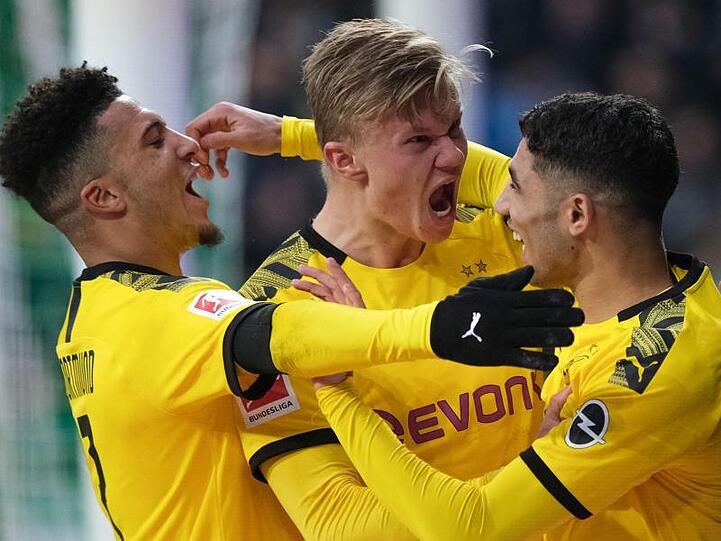 Dortmunds Stürmer Erling Haaland (M) bejubelt seinen Treffer gegen Werder Bremen mit Jadon Sancho (l) und Achraf Hakimi.