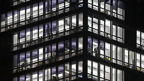 Beleuchtete und unbeleuchtete B&uuml;ros in einem B&uuml;rogeb&auml;ude in M&uuml;nchen.