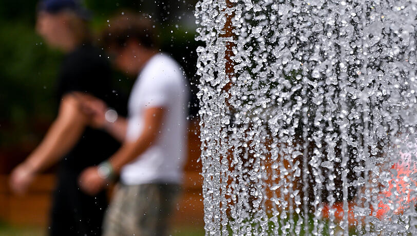 Zwei Männer gehen vor dem Lenbachhaus an einem Springbrunnen entlang. In München ist die Bevölkerung zum Wassersparen angehalten. Zwei Männer gehen vor dem Lenbachhaus an einem Springbrunnen entlang. In München ist die Bevölkerung zum Wassersparen angehalten.
