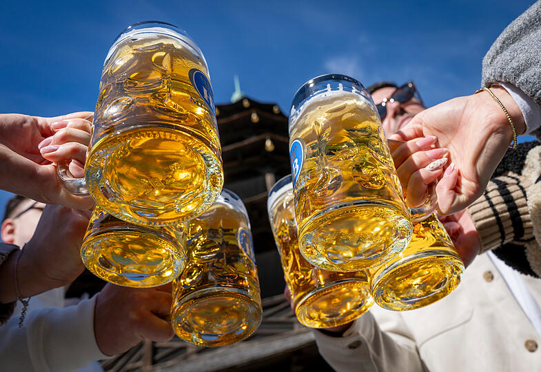 Auf den Fr&uuml;hling: Ansto&szlig;en mit Bierkr&uuml;gen am Chinesischen Turm.