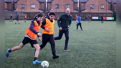 Prinz William spielt mit Teenagern Fußball.