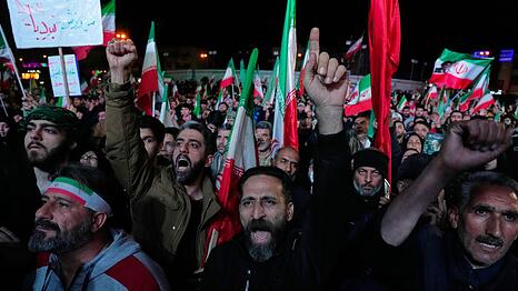 Regierungsanh&auml;nger feiern nach der Ank&uuml;ndigung der Waffenruhe in Teheran.