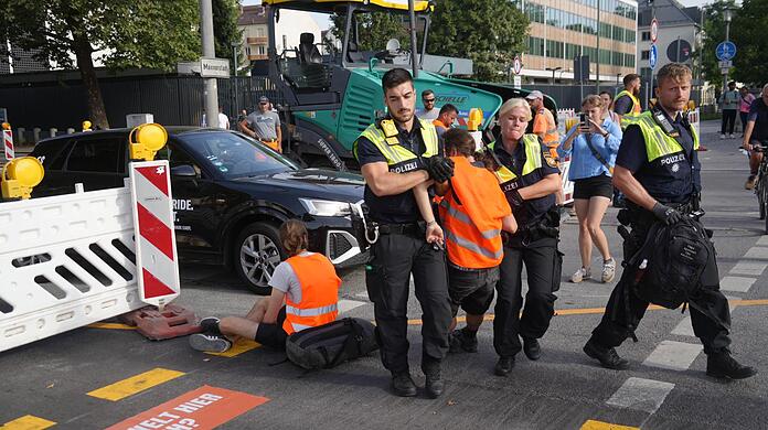 Die Polizei trägt einen Aktivisten der "Letzten Generation" von der Straße.