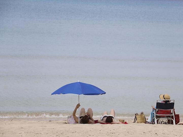 Menschen sonnen sich am Strand von Arenal auf Mallorca. Bislang dürfen aber noch keine ausländischen Touristen nach Spanien.