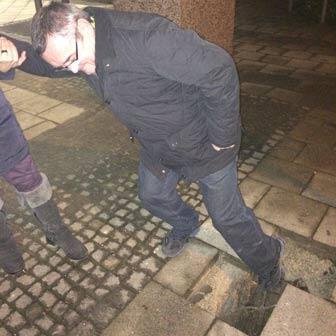 Hier wäre er beinahe vom Erdboden verschluckt worden: Norman W. zeigt mit dem Fuß auf das Loch im Gehweg.