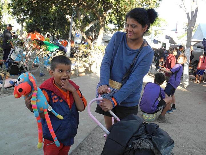 Sie will über die Grenze und lässt sich nicht entmutigen: Karen Aguilera aus Honduras steht mit ihrem Sohn Justin am Rand eines kleinen Spielplatzes in Tijuana.