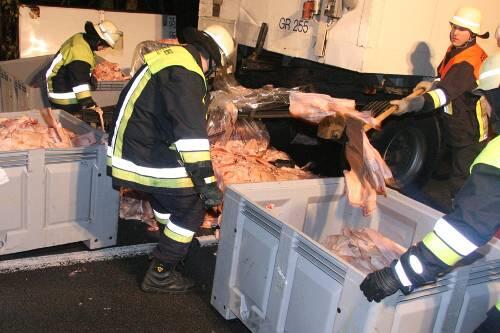 Feuerwehrmänner bergen die Ladung Schweineschwarten