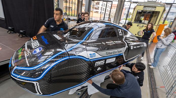 Studierende der TU München transportieren einen von ihnen entwickelten Prototypen des elektrischen Kleinfahrzeugs "muc023" bei einer Vorstellung in das Verkehrszentrum des Deutschen Museums.