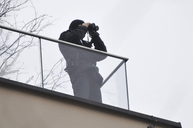 Die Überwachung in der Stadt wird zugunsten der Sicherheit massiv aufgestockt. Hier beobachtet ein Polizist das Geschehen vom Dach des Hotels Bayerischen Hof aus (Archivbild) - zu ähnlichen Szenen wird es auch am Wochenende wieder kommen.