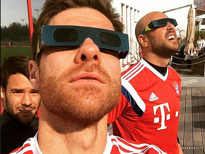 FC Bayern-Star Xabi Alonso (vorne) beobachtet mit Kollegen die Sonnenfinsternis