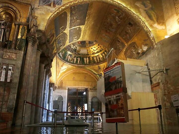 Der Eingangsbereich zum Markusdom ist überflutet, das Hochwasser hat Schäden am Mauerwerk angerichtet.