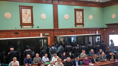 Die angeklagten Terroristen sa&szlig;en w&auml;hrend des Prozesses schwer bewacht in Glask&auml;figen.